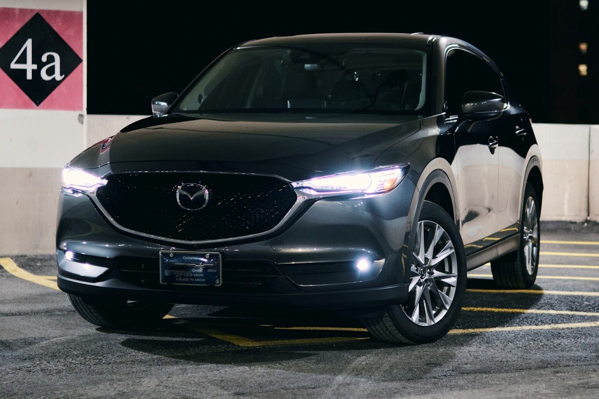 Black Mazda CX-5 under showroom lighting