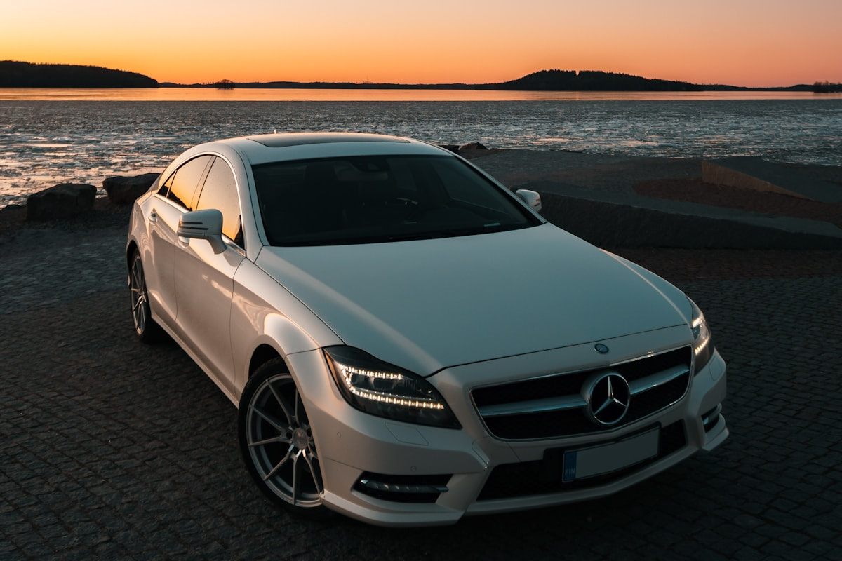 Silver Mercedes-Benz saloon at sunset