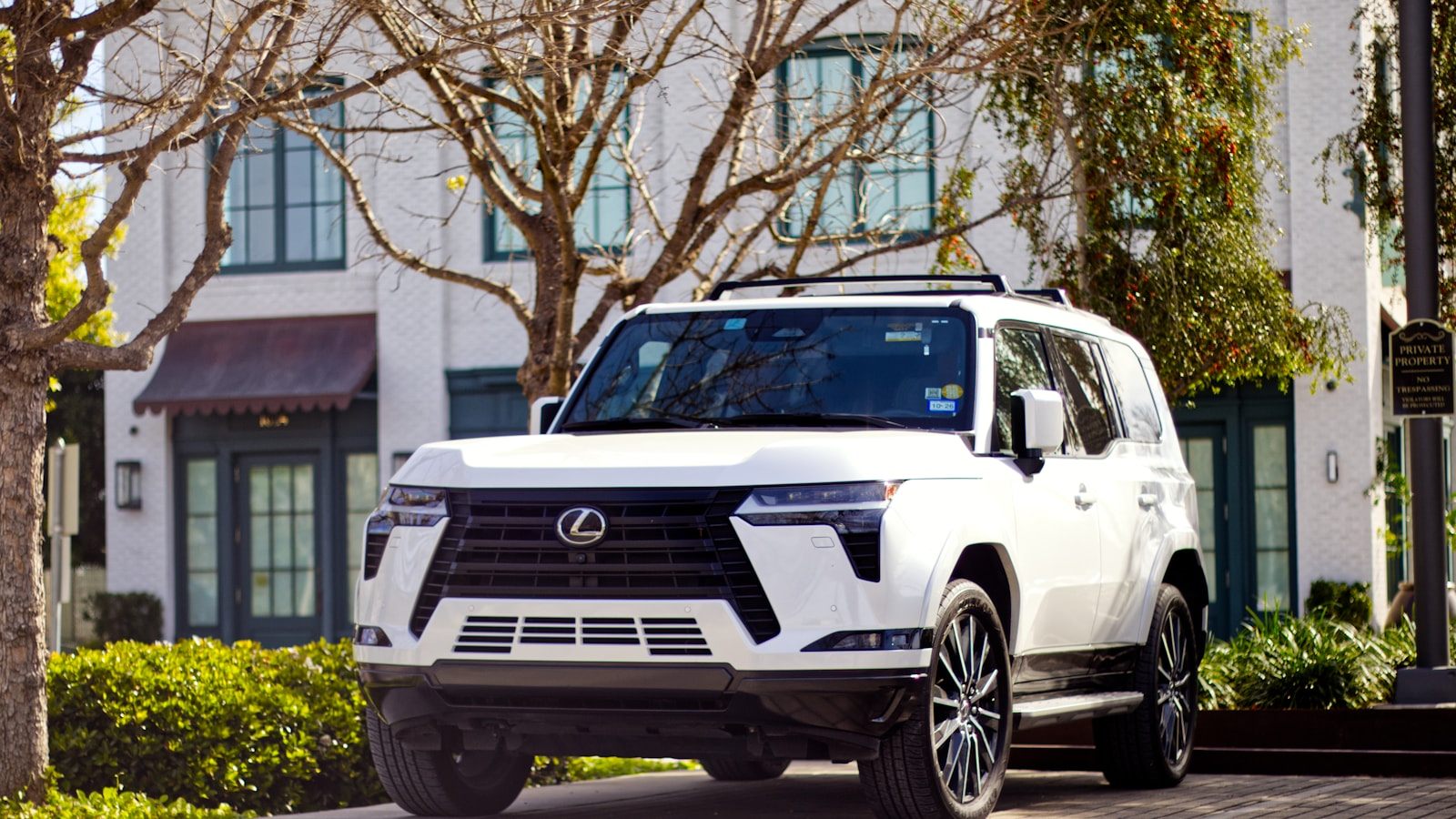 White Lexus SUV outside a dealership